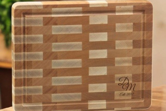 Hardwood cutting board with a laser engraved monogram