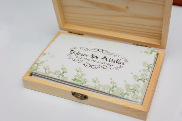 Open wooden wedding keepsake box holding advice and wishes cards
